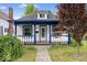 Charming home featuring a front porch with blue trim and manicured landscaping at 57 E South St, Mooresville, IN 46158