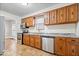 Well-lit kitchen featuring wood cabinets, tile floors, stainless steel appliances, and neutral walls at 57 E South St, Mooresville, IN 46158