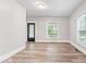 Bright living room features hardwood floors, neutral walls, and plenty of natural light from multiple windows at 57 E South St, Mooresville, IN 46158