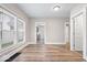 Bright living room featuring hardwood floors, neutral walls, and plenty of natural light from multiple windows at 57 E South St, Mooresville, IN 46158