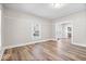 Spacious living room featuring hardwood floors, neutral walls, and an open doorway to the kitchen at 57 E South St, Mooresville, IN 46158