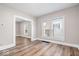 Bright living room featuring hardwood floors, neutral walls, and plenty of natural light from multiple windows at 57 E South St, Mooresville, IN 46158
