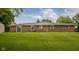 View of the brick house from the backyard, showing the expansive lawn at 5749 Teresa Dr, Alexandria, IN 46001