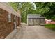 Brick house with backyard shed and patio area, perfect for outdoor activities and storage at 5749 Teresa Dr, Alexandria, IN 46001