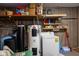 Functional basement area with a water heater, washer, storage shelves, and paneling on the walls at 5749 Teresa Dr, Alexandria, IN 46001