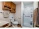 Well-lit bathroom featuring a shower, toilet, vanity with overhead cabinets, and neutral decor at 5749 Teresa Dr, Alexandria, IN 46001