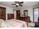 Traditional-style bedroom with matching dresser, a ceiling fan, and doorway access to the ensuite bathroom at 5749 Teresa Dr, Alexandria, IN 46001