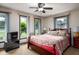 Cozy bedroom featuring natural light, ceiling fan, and a comfortable bed with floral patterned bedding at 5749 Teresa Dr, Alexandria, IN 46001