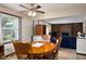The dining area features a wood table, ceiling fan, and seamless flow to the living area at 5749 Teresa Dr, Alexandria, IN 46001