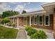 Close up of the front porch showing brick exterior and manicured landscaping at 5749 Teresa Dr, Alexandria, IN 46001