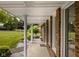 View of the covered front porch showcasing the home's brick facade and well-maintained landscaping at 5749 Teresa Dr, Alexandria, IN 46001