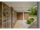 Covered front porch view features brick exterior and tasteful landscaping at 5749 Teresa Dr, Alexandria, IN 46001