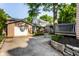 Spacious backyard with a detached garage, basketball hoop, and a well-maintained stone flowerbed at 5760 Central N Ave, Indianapolis, IN 46220