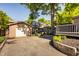 Backyard featuring a detached garage, driveway and a basketball hoop at 5760 Central N Ave, Indianapolis, IN 46220