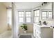 Bright bathroom with a bathtub and shower combination and white vanity at 5760 Central N Ave, Indianapolis, IN 46220