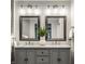 Bathroom vanity with double sinks, granite countertop, and decorative mirrors at 5760 Central N Ave, Indianapolis, IN 46220