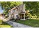 Charming two-story home with a covered porch, landscaped yard, and private driveway at 5760 Central N Ave, Indianapolis, IN 46220