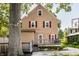 Back exterior view of a traditional home featuring a deck, large yard and outdoor lighting at 5760 Central N Ave, Indianapolis, IN 46220