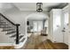 Inviting foyer with hardwood floors, staircase, and an archway leading to the living room at 5760 Central N Ave, Indianapolis, IN 46220