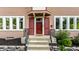 Close-up view of the front door with red shutters, complemented by landscaping at 5760 Central N Ave, Indianapolis, IN 46220