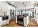 Modern kitchen featuring stainless steel appliances, an island, and an open floor plan at 5760 Central N Ave, Indianapolis, IN 46220