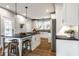Bright, modern kitchen with white cabinets, dark countertops and hardwood floors at 5760 Central N Ave, Indianapolis, IN 46220