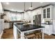 Bright, modern kitchen island with white cabinets, dark countertops and hardwood floors at 5760 Central N Ave, Indianapolis, IN 46220