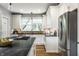 Modern kitchen featuring white cabinets, dark countertops, and stainless steel appliances at 5760 Central N Ave, Indianapolis, IN 46220