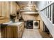Basement laundry room with wooden cabinets and newer washer and dryer units, offering convenience and storage at 5760 Central N Ave, Indianapolis, IN 46220