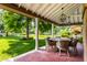 Charming covered porch with ample seating, perfect for outdoor dining and relaxation overlooking the lush front yard at 5760 Central N Ave, Indianapolis, IN 46220