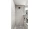 Modern walk-in shower with subway tile, a pebble floor, and convenient built-in shelving at 5760 Central N Ave, Indianapolis, IN 46220