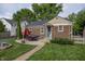 Charming backyard with a brick patio, lush green lawn, and mature trees providing privacy at 5829 Indianola Ave, Indianapolis, IN 46220