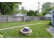 Beautiful backyard featuring a brick fire pit, brick paver path, green grass, and wood fence at 5829 Indianola Ave, Indianapolis, IN 46220