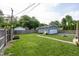 Large backyard featuring a detached garage, brick path, and expansive lawn at 5829 Indianola Ave, Indianapolis, IN 46220