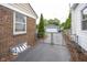 View of the driveway leading to a detached garage with a gated fence at 5829 Indianola Ave, Indianapolis, IN 46220