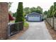 Driveway view with a detached garage and green trees in the background at 5829 Indianola Ave, Indianapolis, IN 46220