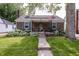 Charming brick home with a cozy porch and well-manicured lawn at 5829 Indianola Ave, Indianapolis, IN 46220