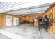 Spacious garage interior with a door, overhead lighting, storage shelves, and workbench at 5829 Indianola Ave, Indianapolis, IN 46220