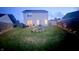 Well-lit backyard with patio, fire pit, privacy fence and enchanting outdoor lighting for evening enjoyment at 5924 Sable Dr, Indianapolis, IN 46221
