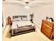 Comfortable bedroom with a full-sized bed, carpeted floor, closet storage, and ceiling fan, a peaceful retreat at 5924 Sable Dr, Indianapolis, IN 46221