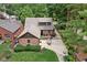 Birds eye view displays a property with a patio area, manicured lawn, and mature trees at 5946 Guilford Ave, Indianapolis, IN 46220