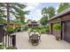 Landscaped backyard featuring a patio dining set, well-maintained lawn, and charming outbuildings at 5946 Guilford Ave, Indianapolis, IN 46220