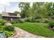 The backyard has a luscious lawn with beautiful landscape and stone pathway to the cozy finished garage at 5946 Guilford Ave, Indianapolis, IN 46220