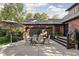 Charming backyard patio with outdoor seating, well-kept lawn, and access to the brick home at 5946 Guilford Ave, Indianapolis, IN 46220