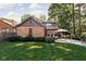 Scenic backyard featuring a lush lawn, mature trees, and an outdoor dining area at 5946 Guilford Ave, Indianapolis, IN 46220