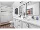 Bright bathroom features a double sink vanity, modern fixtures, and a glass-enclosed shower with sleek tile work at 5946 Guilford Ave, Indianapolis, IN 46220