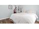 Cozy bedroom showcasing a plush bed, hardwood floors, a closet, and soft decor at 5946 Guilford Ave, Indianapolis, IN 46220