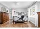 Serene bedroom featuring a wrought iron bed, hardwood floors, and natural light from the windows at 5946 Guilford Ave, Indianapolis, IN 46220