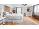 Spacious bedroom with hardwood floors, a patterned rug, and a comfy bed with pillows at 5946 Guilford Ave, Indianapolis, IN 46220