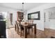 Dining room with a wooden table and chairs, chandelier, hardwood floors and door with stained glass at 5946 Guilford Ave, Indianapolis, IN 46220
